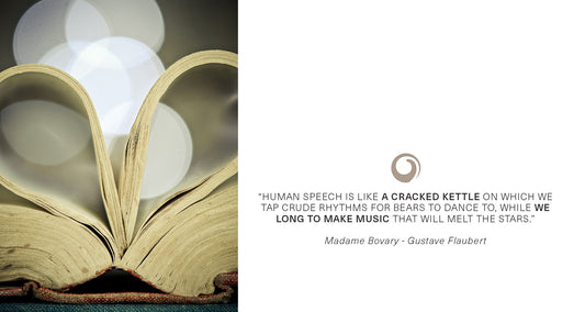 Open book with pages shaped like a heart and quote from Madame Bovary